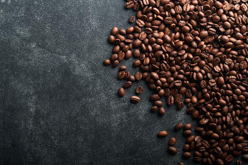Coffee beans background. Roasted coffee beans. View from above. Coffee concept. Mock up.