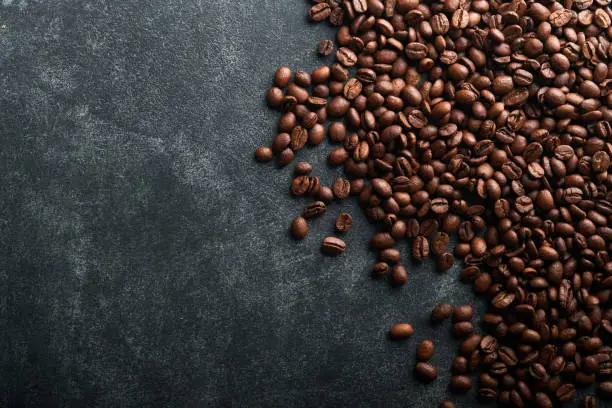 Photo of Coffee beans background. Roasted coffee beans. View from above. Coffee concept. Mock up.