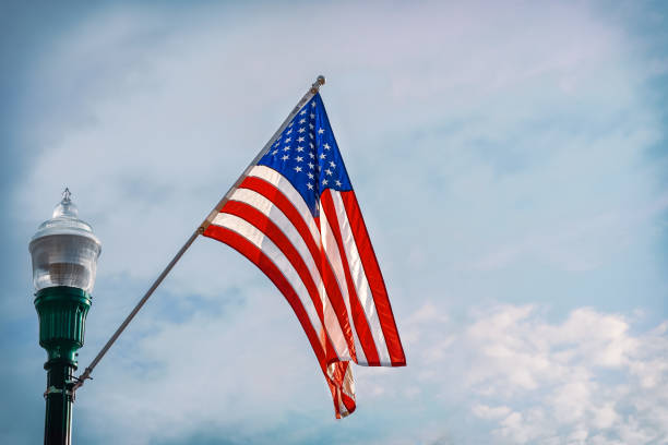American flag during a 4th of July celebration. Blue sky background.