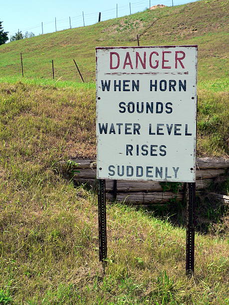 istock Sign indicates danger on a hill - When Horn Sounds Water Level R 139401891