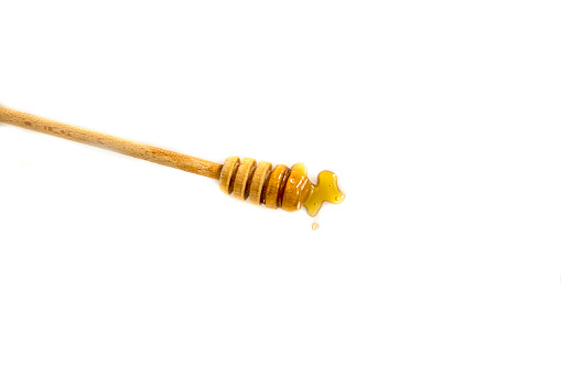 Honey dripping isolated on white