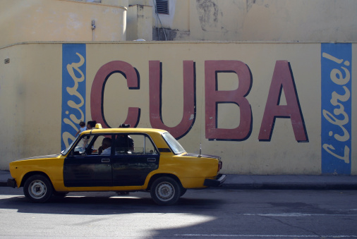 Cuba libre sign on wall with taxi, Havana, Cuba