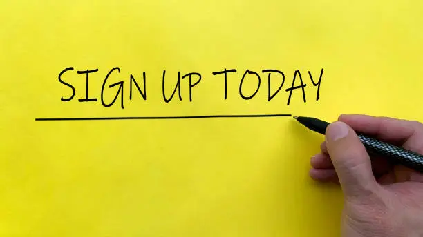 Photo of Hand writing a text of Sign Up Today on yellow background. Online business concept