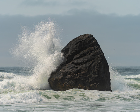 Crashing Wave on Beach Rock Formation