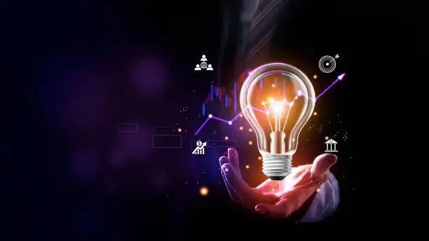 Photo of Businessman holding a bright light bulb. Concept of Ideas for presenting new ideas Great inspiration and innovation new beginning. Futuristic tone purple, neon color. Analyzing data