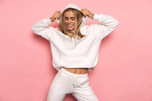 Beautiful smiling blonde woman wear of white set of tracksuit stock photo