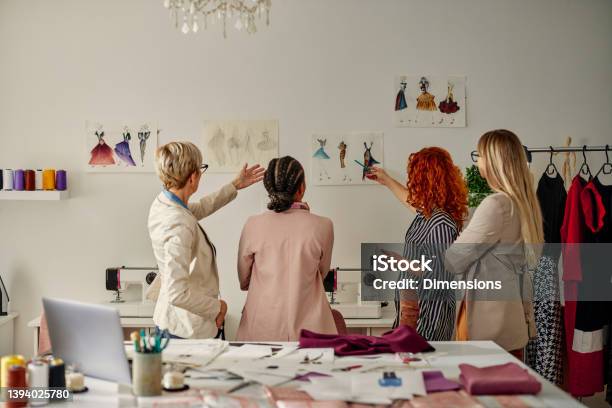 Four Female Coworkers Working On Their Fashion Design Stock Photo - Download Image Now