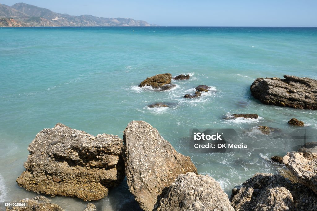 South part of the Calahonda Beach (Playa de la Calahonda), Nerja, Malaga, Spain. South part of the Calahonda Beach (Playa de la Calahonda), Nerja, Malaga, Spain. It is  Nerja’s most iconic beach. Backgrounds Stock Photo