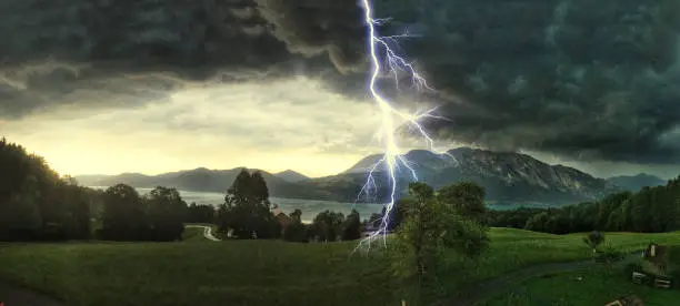 Thunderstorm with lightning strikes over the Alps at Lake Attersee, Salzburg Austria, Concept for insurance damage, security, severe weather and climate change
