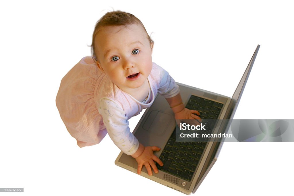 Baby with Laptop Little girl looking up from her work. Focus is on her face. Baby - Human Age Stock Photo