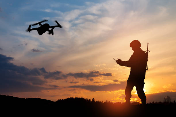 la silueta del soldado está utilizando drones y computadoras portátiles para explorar durante la operación militar. - armada fotografías e imágenes de stock