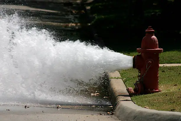 A photograph taken of a fire hydrant releasing some pressure one hot Oklahoma day.