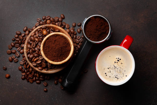 istock Roasted coffee beans and ground coffee in filter holder 1394028080