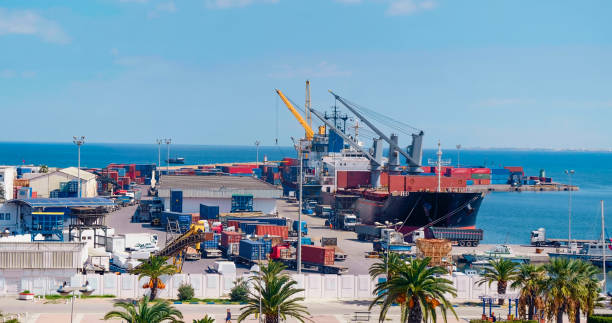 istock International containers cargo ship loading and unloading in Port of Sousse. 1394030558