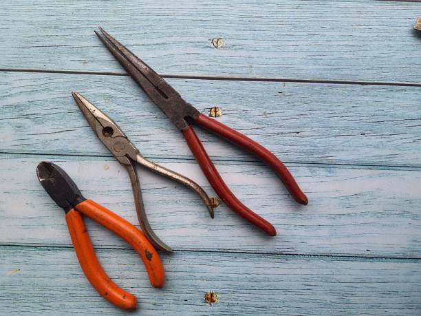 Pliers, Pliers, three different types of pliers, on a wooden table, top view, copy space wire cutter stock pictures, royalty-free photos & images