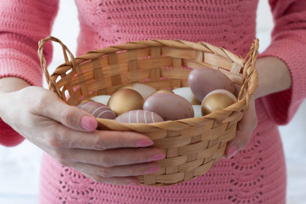 istock A woman holds an Easter basket with eggs in her hands 1394034742