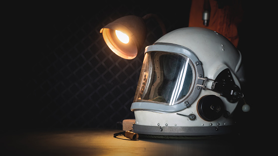 Concept of astronaut helmet on the table of the orbital station background with copy space.