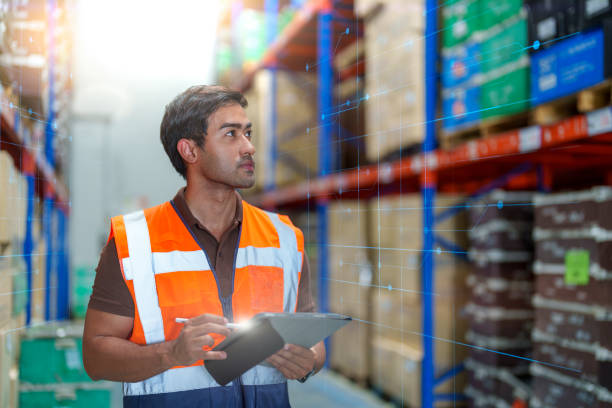 istock Man warehouse worker holding digital tablet in warehouse. 1394037826