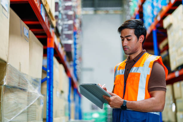 istock Man warehouse worker holding digital tablet in warehouse. 1394038026
