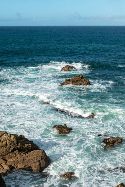 breaking waves on the rocky coast in brittany stock photo