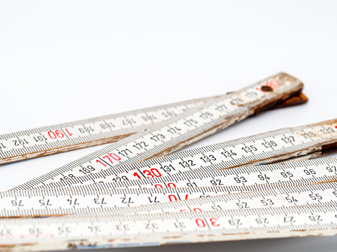 View of the wooden ruler and the millimeter and centimeter scales with red and black numbers. A measuring instrument for craftsmen and do-it-yourselfers