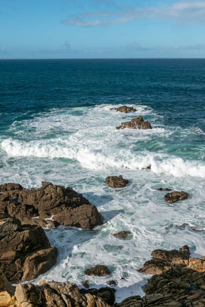 breaking waves on the rocky coast in brittany stock photo
