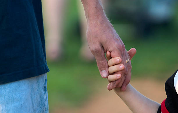 istock father holding child's hand 139404078