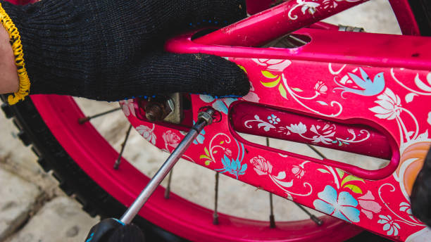 istock A father repairs his daughter's bike. 1394041361