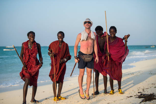 Zanzibar, Tanzania - January 02,2019: Masai warriors dressed in traditional clothes on sand beach of Zanzibar island.