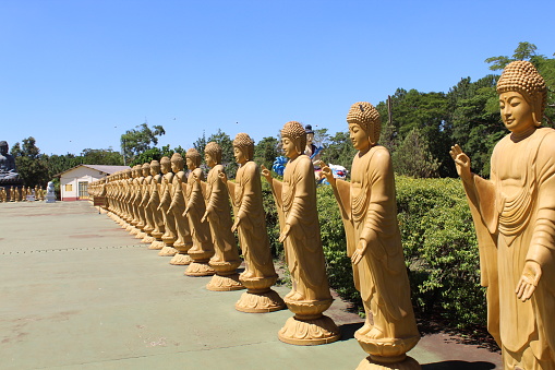 Image of several sculptures in a row in a buddish place in Foz do Iguaçu