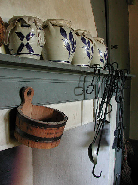 Farm Life: Fireplace Mantle A fireplace mantle with cooking utensils and jars, as it would have been in the 1800's. mickey mantle stock pictures, royalty-free photos & images