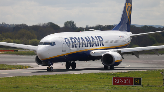 Manchester Airport, United Kingdom - 18 April, 2022: Ryanair Boeing 737 (EI-DHS) vacating runway 23R after landing from Alicante, Spain.