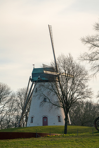 This beautiful Mountain mill is located in Anzegem Belgium, with the rise of the sun and heavily cloudy