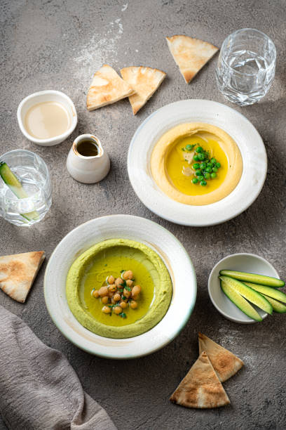 istock Snow peas Hummus and chick peas hummus, with water and fresh vegetables 1394049961