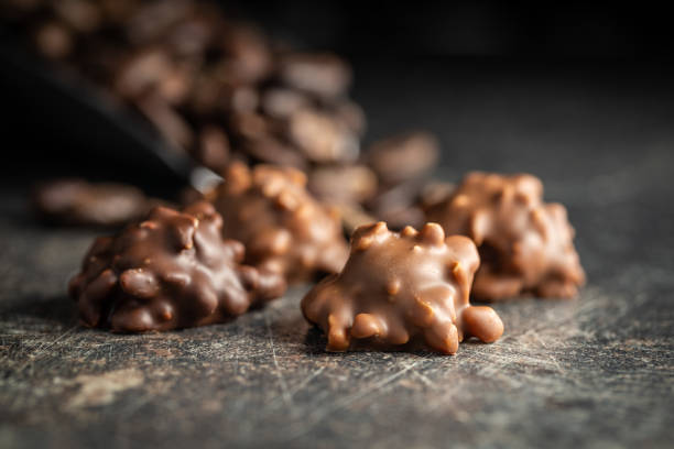 istock Chocolate truffles. Sweet pralines on black table. 1394051110