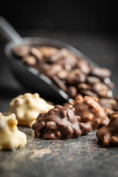 istock Chocolate truffles. Sweet pralines on black table. 1394051111