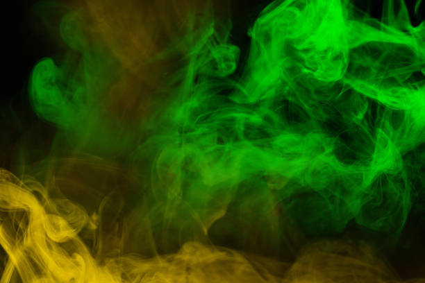 istock Yellow steam on a black background. 1394051875