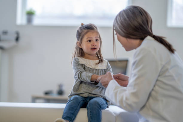 istock Female Doctor with a Young Patient 1394052055