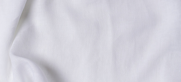White crumpled linen fabric texture background. Natural linen organic eco textiles canvas background