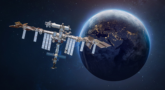 International space station in outer space. ISS on orbit of Earth planet. Space sci-fi collage with satellite and spaceship. Astronauts on orbit. Elements of this image furnished by NASA (url: https://www.nasa.gov/sites/default/files/styles/full_width_feature/public/thumbnails/image/iss066e080432.jpg https://eoimages.gsfc.nasa.gov/images/imagerecords/79000/79765/dnb_land_ocean_ice.2012.3600x1800.jpg)