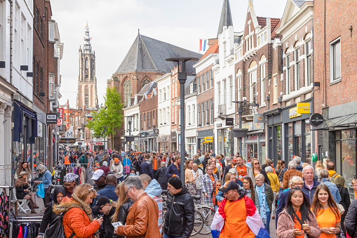 Amersfoort, Netherlands, April 27, 2022; Many people on the street in the center of Amersfoort on King's Day, an annual national holiday in the Netherlands.