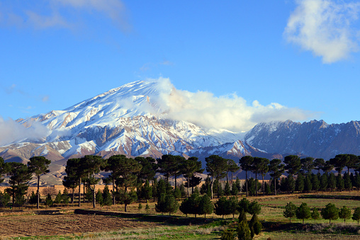 Kholm / Khulm / Tashqurghan, Balkh province, Afghanistan: snow capped mountain peak and the Jahan Nama Palace, the vast gardens now have pine trees and ploughed agricultural fields.