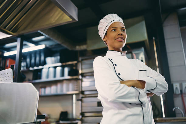 istock Below view of confident black female chef in the kitchen. 1394053836