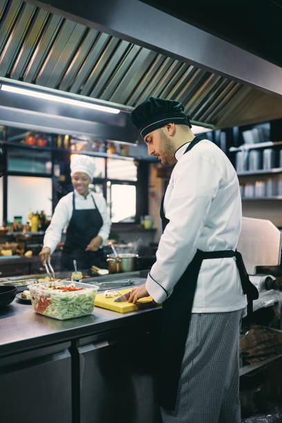 istock Male chef chopping food while working in the kitchen. 1394053950