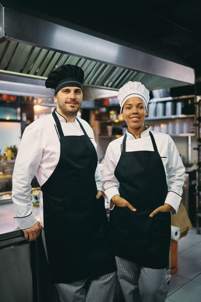 istock Portrait of happy multi-ethnic professional cooks looking at camera. 1394053952