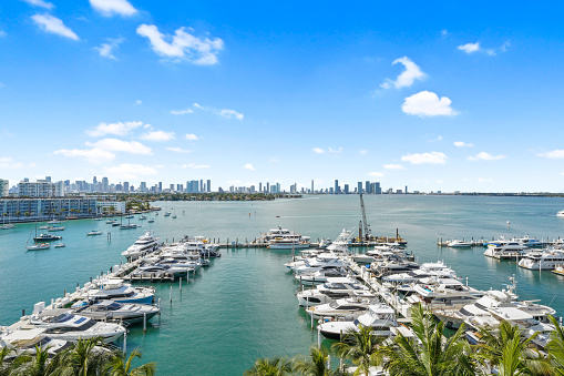 Aerial imagery capture’s a “birds eye view” of a marina in Miami with a skyscraper background