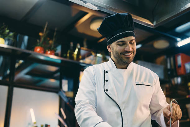 istock Happy chef preparing food while working in the kitchen at restaurant. 1394055913