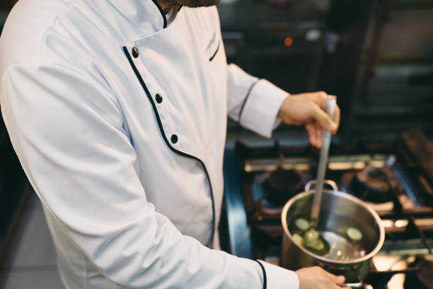 istock Unrecognizable chef cooking while working in the kitchen at restaurant. 1394055968