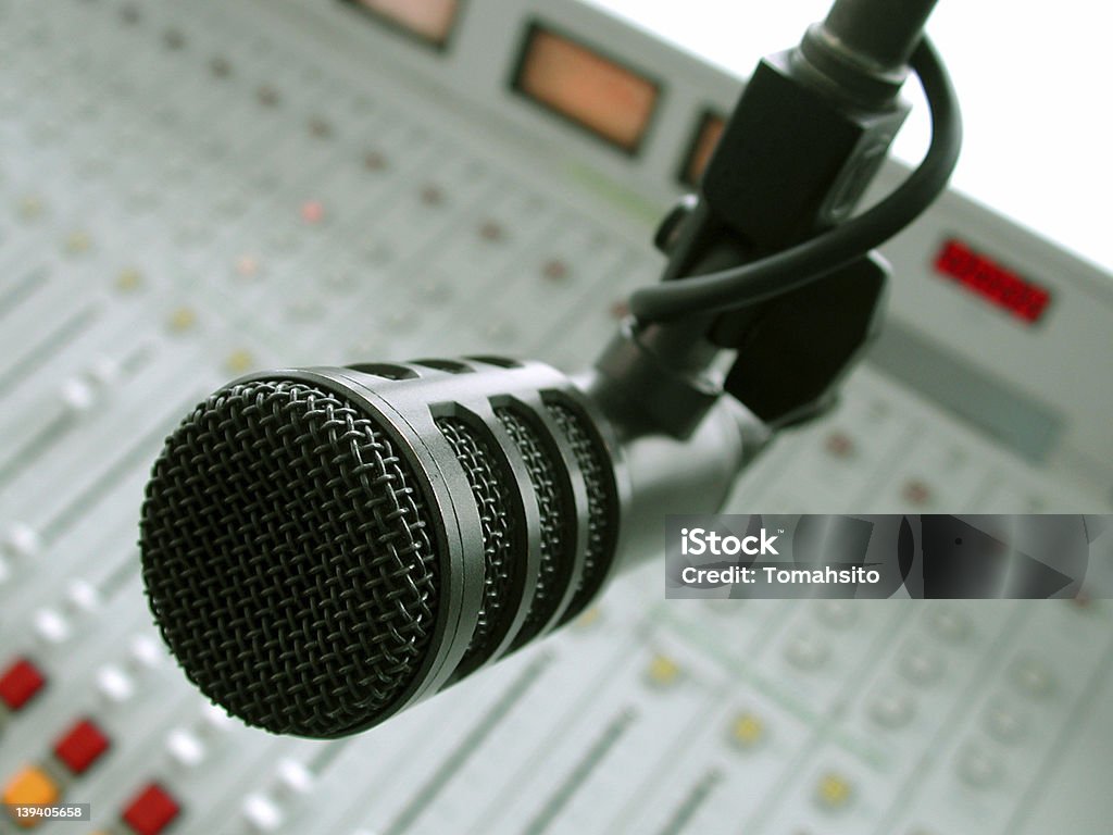 A microphone in a studio ready to use Microphone and Console Horizontal Stock Photo