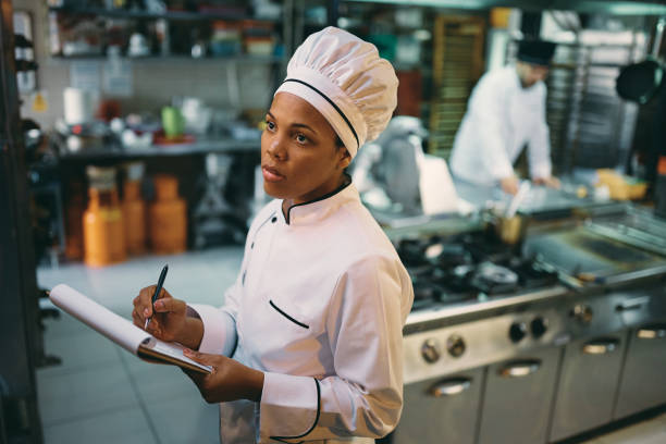 African American chef checking kitchen's supplies while working at restaurant.